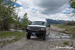 Our Ford E350 4x4 camper van on dirt road, crossing a creek, Montana, USA