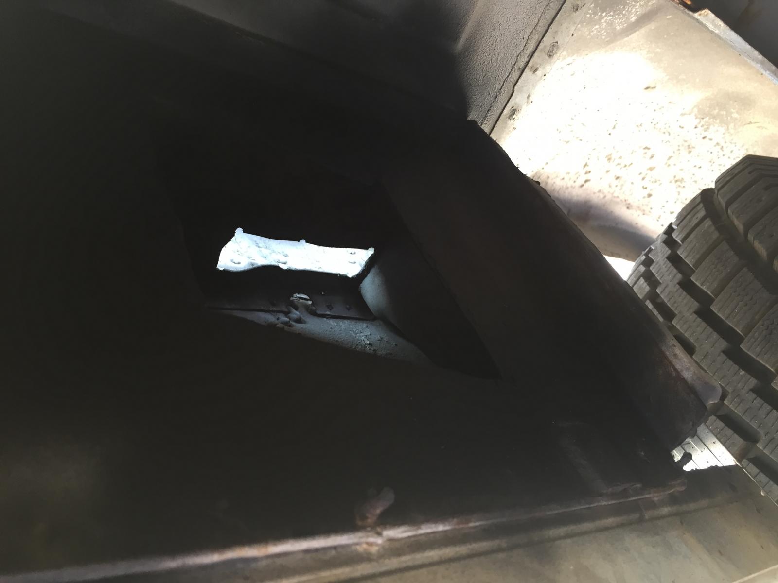 Hole in van floor where rear ac/heater hoses ran. The lights coming through the hole in the floor and this is looking at the second hole cut through wall of the underbody.