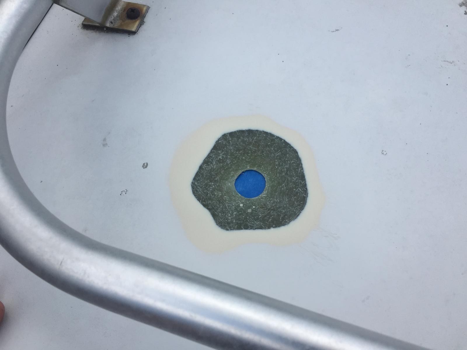 There was a hole in the fiberglass high top roof that an old TV antenna cable ran through. I'm sanding and prepping it to patch with fiberglass and resin. Sanded a tapered circle to fit 4 fiberglass patches of increasing size.