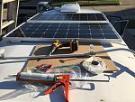 Installing solar panels and reinstalling luggage rack with stainless steel screws and Dicor butyl tape