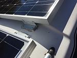 x3 Renogy 100 watt solar panels installed with Renogy Z brackets and plastic wedges underneath to level surface.