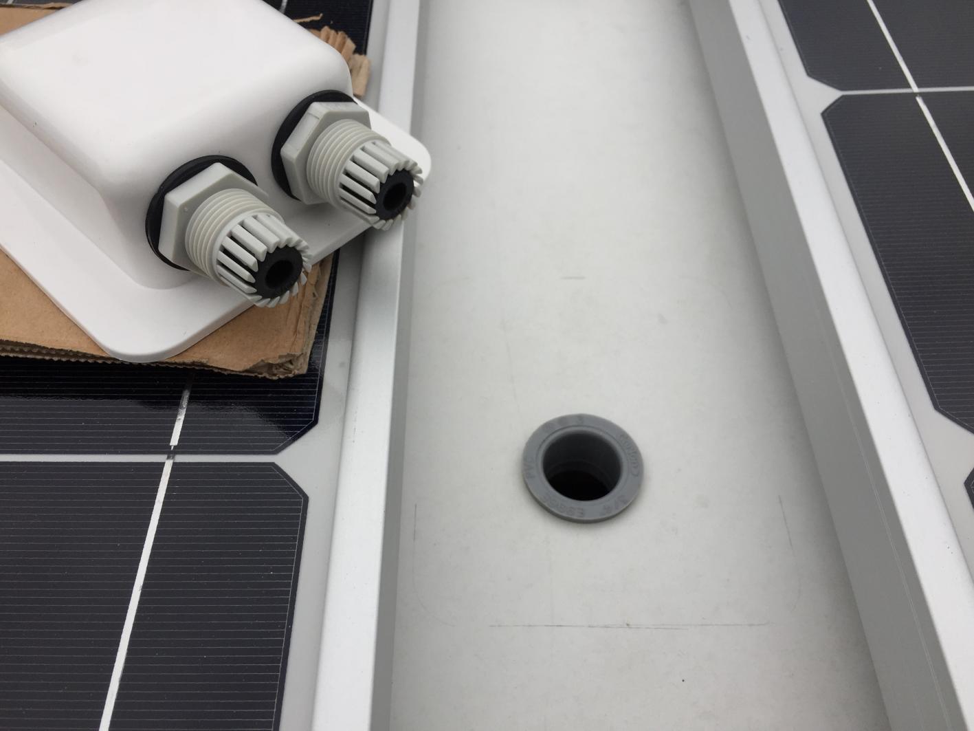 Installing roof cable entry plate for solar panels. Used an electrical or PVC piece in the hole so there's no sharp edge on the cables.