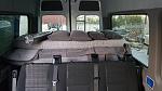 Van's rear photo showing retained seats for passengers (our 3 grand kids) prior to window covers installation, showing the Ikea folding bed & pillows...
