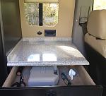 A window, counter, and drawer behind the driver's seat.