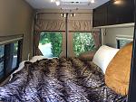 Cozy 72 long by 67 wide bed.  Love lying in bed looking out the windows!  Can open back doors wide and put screen on for open air camping experience.
