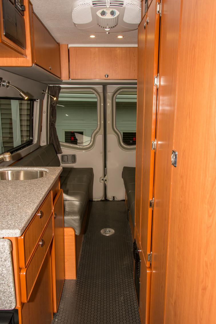 Looking towards the rear of the van.  Storage cabinets installed over the rear dinette.  D5 Hydronic components installed in the bottom compartment of closet between the bathroom and dinette.